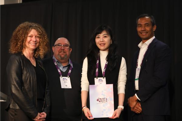 Amy Zheng receiving ADEA award certificate at diabetes education conference with three colleagues