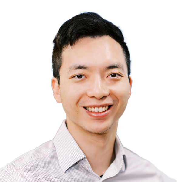 Professional headshot of smiling Asian male doctor in light grey checkered shirt against white background