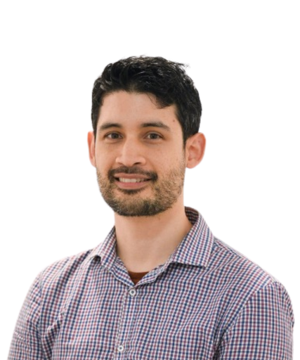 Professional headshot of male healthcare practitioner in checkered shirt smiling at camera