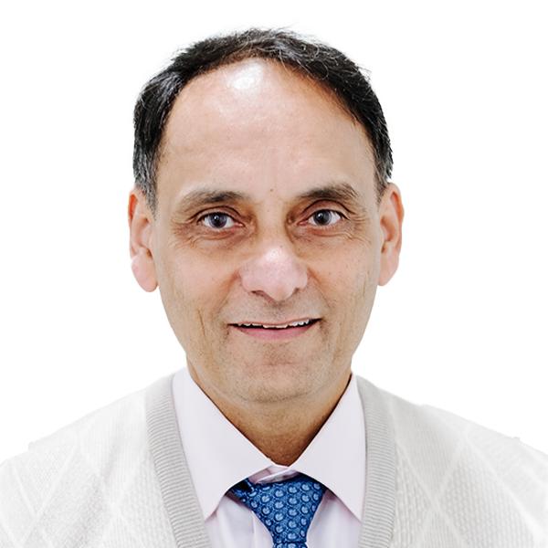 Professional headshot of male doctor in white coat with blue patterned tie smiling at camera