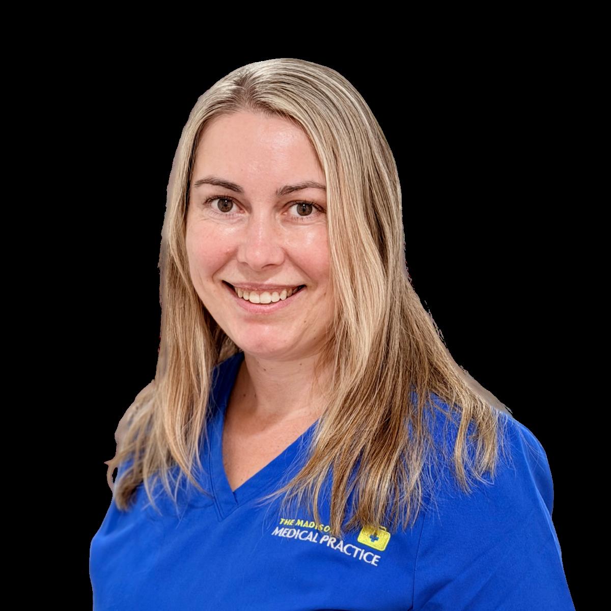 Healthcare professional in blue medical scrubs smiling at camera