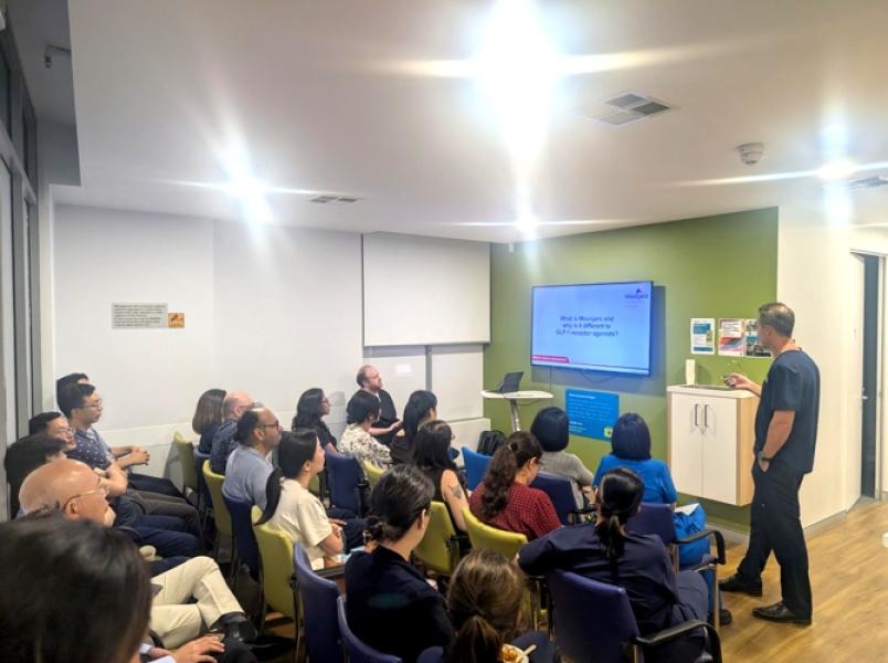 Healthcare professionals and staff members attending a medical education seminar in a clinical training room