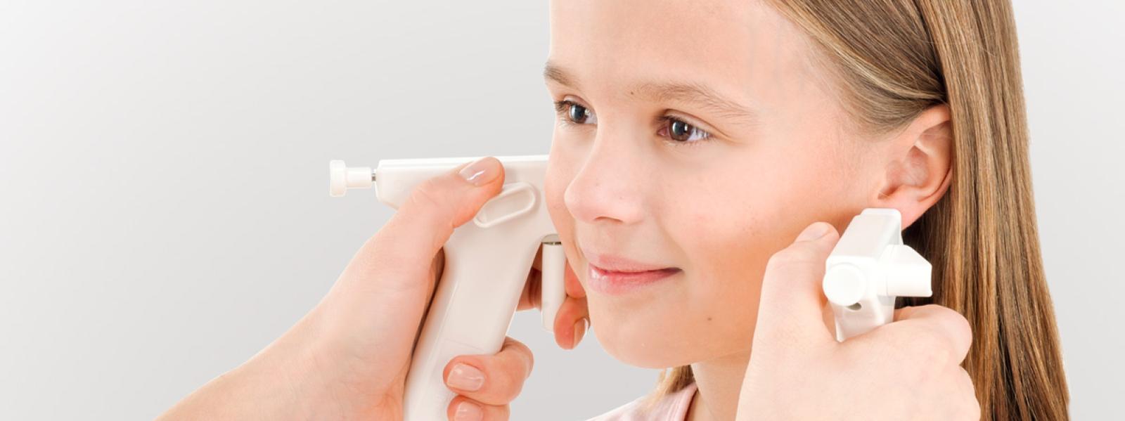Child using nasal spray inhaler for allergy or cold relief treatment