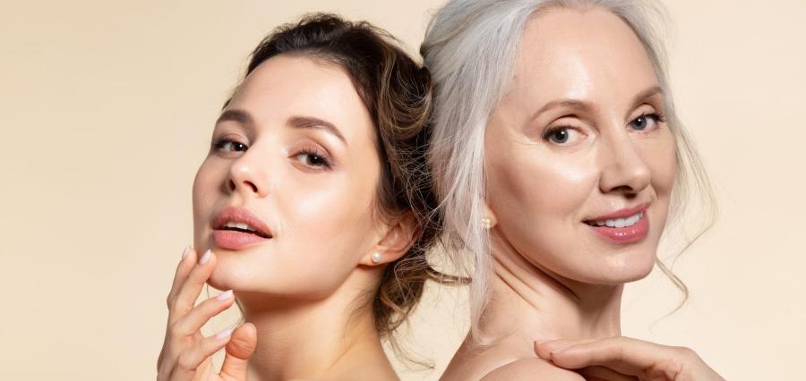 Two women of different ages displaying healthy, radiant skin against a neutral background